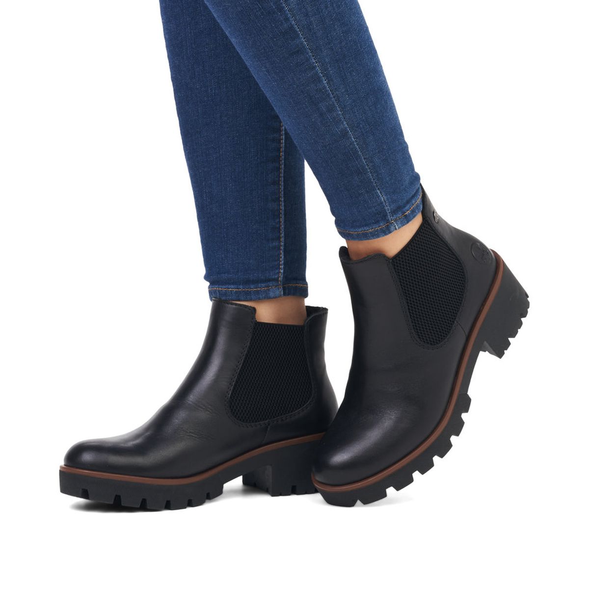 Rieker 79265 Women’s Black Chelsea Boots featuring smooth synthetic uppers, elastic side panels, short fur lining, and a 51mm block heel for stylish comfort.