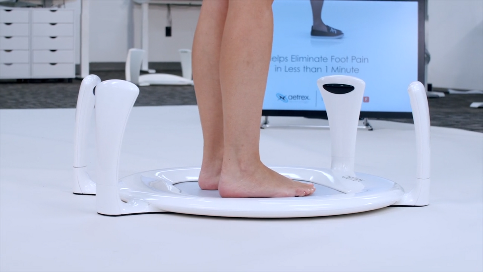 A person's feet on the Aetrex In Store Foot Scanning Technology machine