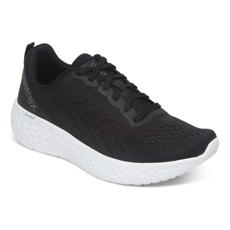 Front and side views of the Aetrex Danika Black Wide sneaker featuring breathable black mesh upper, padded collar, and durable rubber outsole with traction pods.