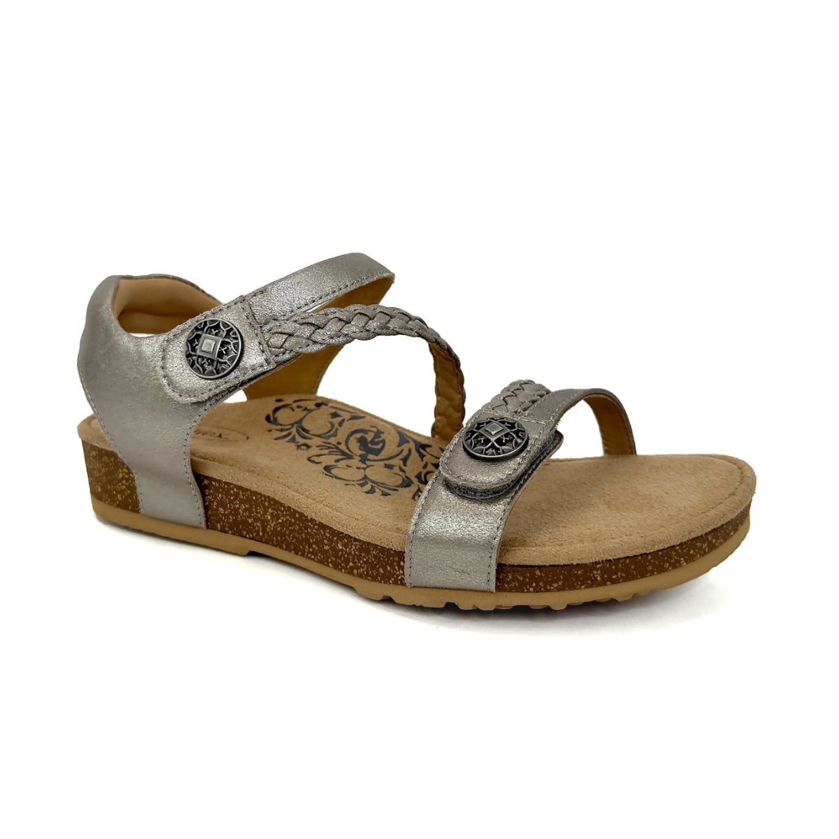 Brushed silver leather sandal with two wide, adjustable hook-and-loop straps across the forefoot and instep, a padded strap around the heel, and a slightly textured metallic finish. Features a contoured footbed, visible arch support, and a low wedge sole with a rubber bottom.