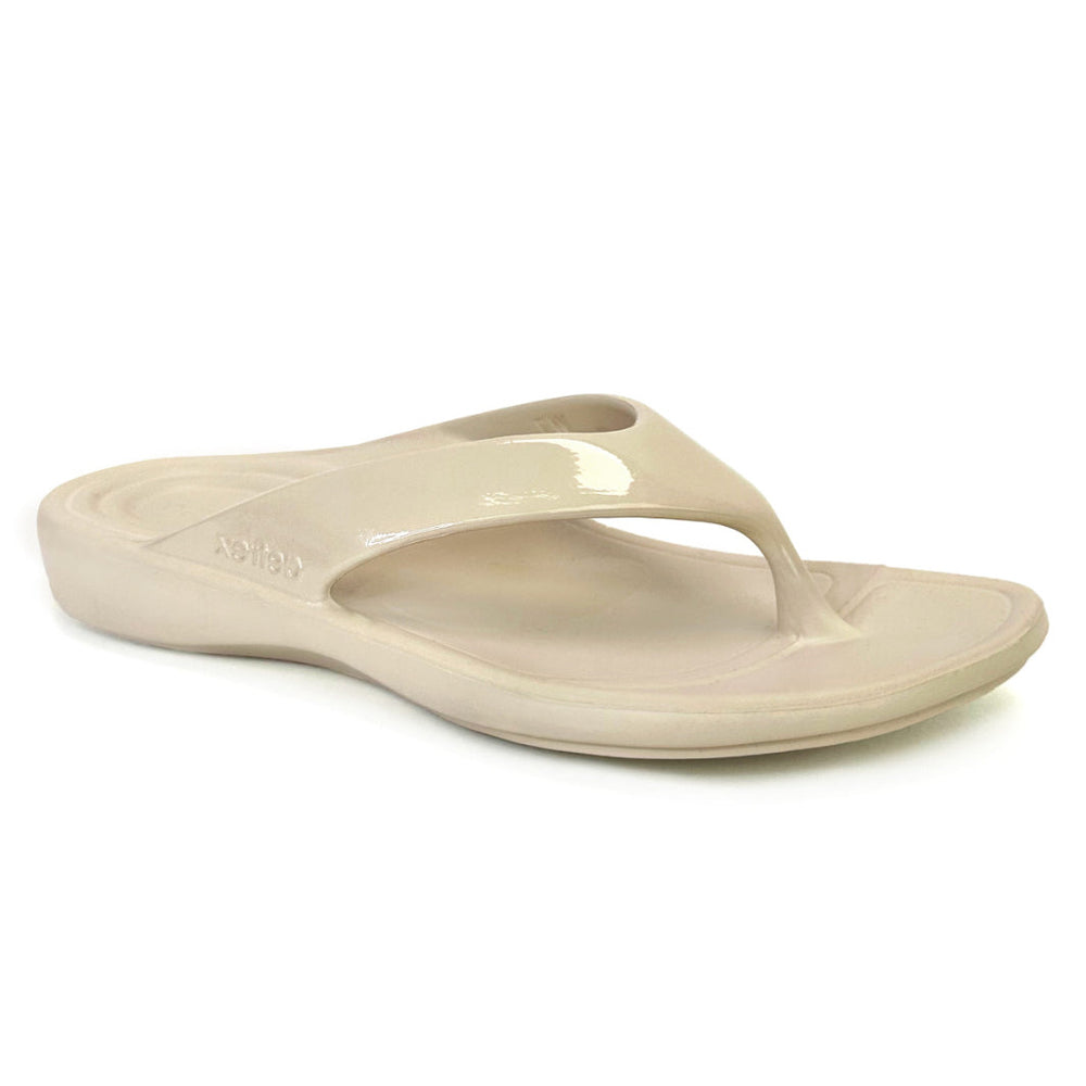 Ivory gloss flip-flop sandal with contoured footbed, soft toe post, and subtle shine. Made from single-piece UltraSky™ EVA foam with arch support and water-friendly construction for stylish pain relief in warm weather. Style #L31033W