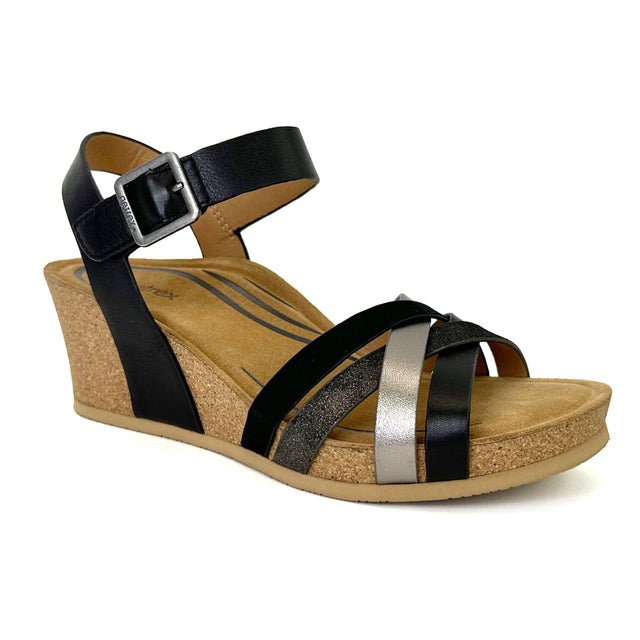Women's black Aetrex Noelle shoe with a sleek leather upper, rounded toe, and subtle stitching details; features dual hook-and-loop straps across the top with elastic side panels for adjustability, set on a 2.25-inch wedge-style heel with a cushioned memory foam footbed and a textured rubber outsole for grip.