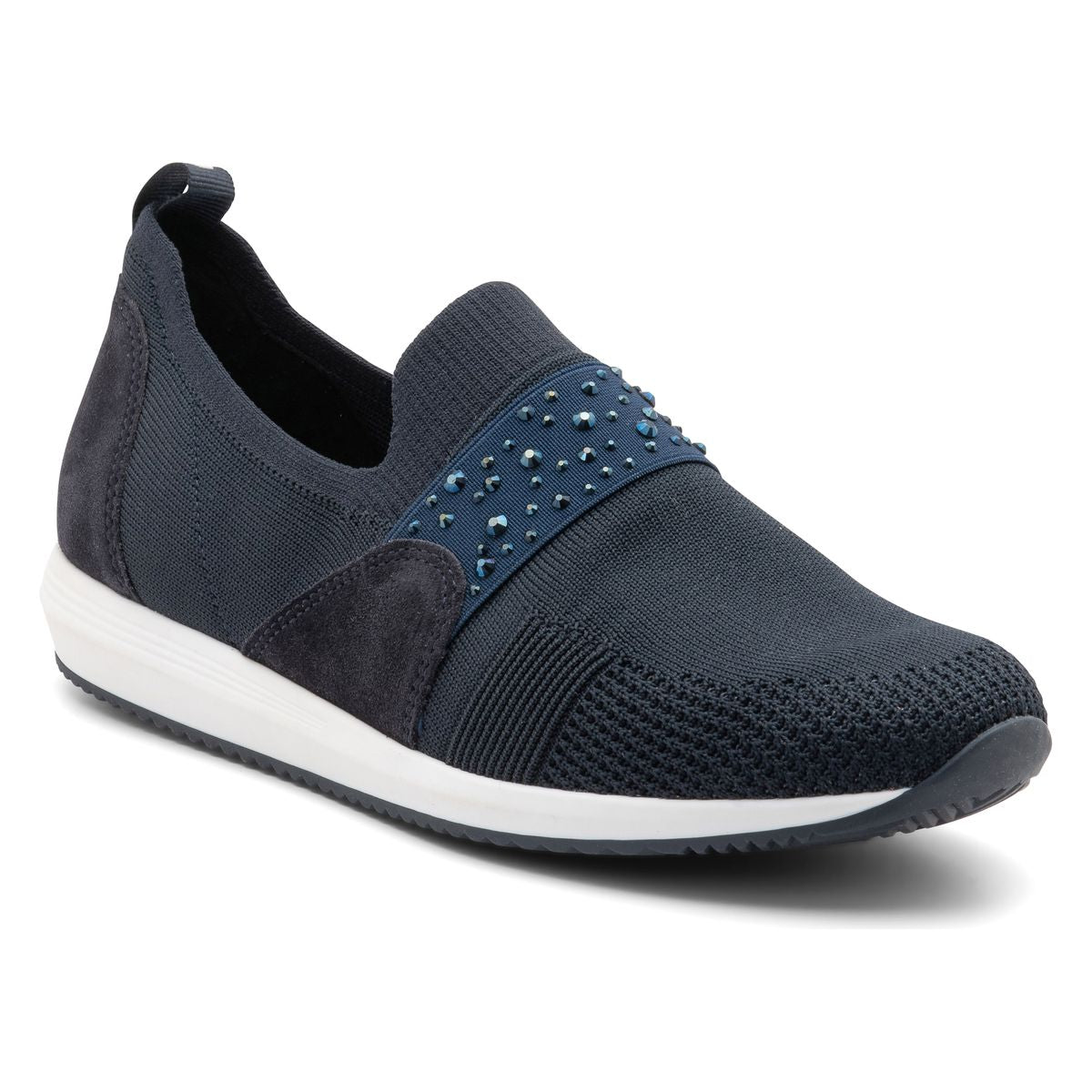 Women’s slip-on sneaker in black stretch-knit fabric with rounded toe, elasticized topline, and subtle heel tab. Features a cushioned removable insole, flexible shock-absorbing sole, and a sleek, minimal design for versatile everyday wear. Style #14003-02