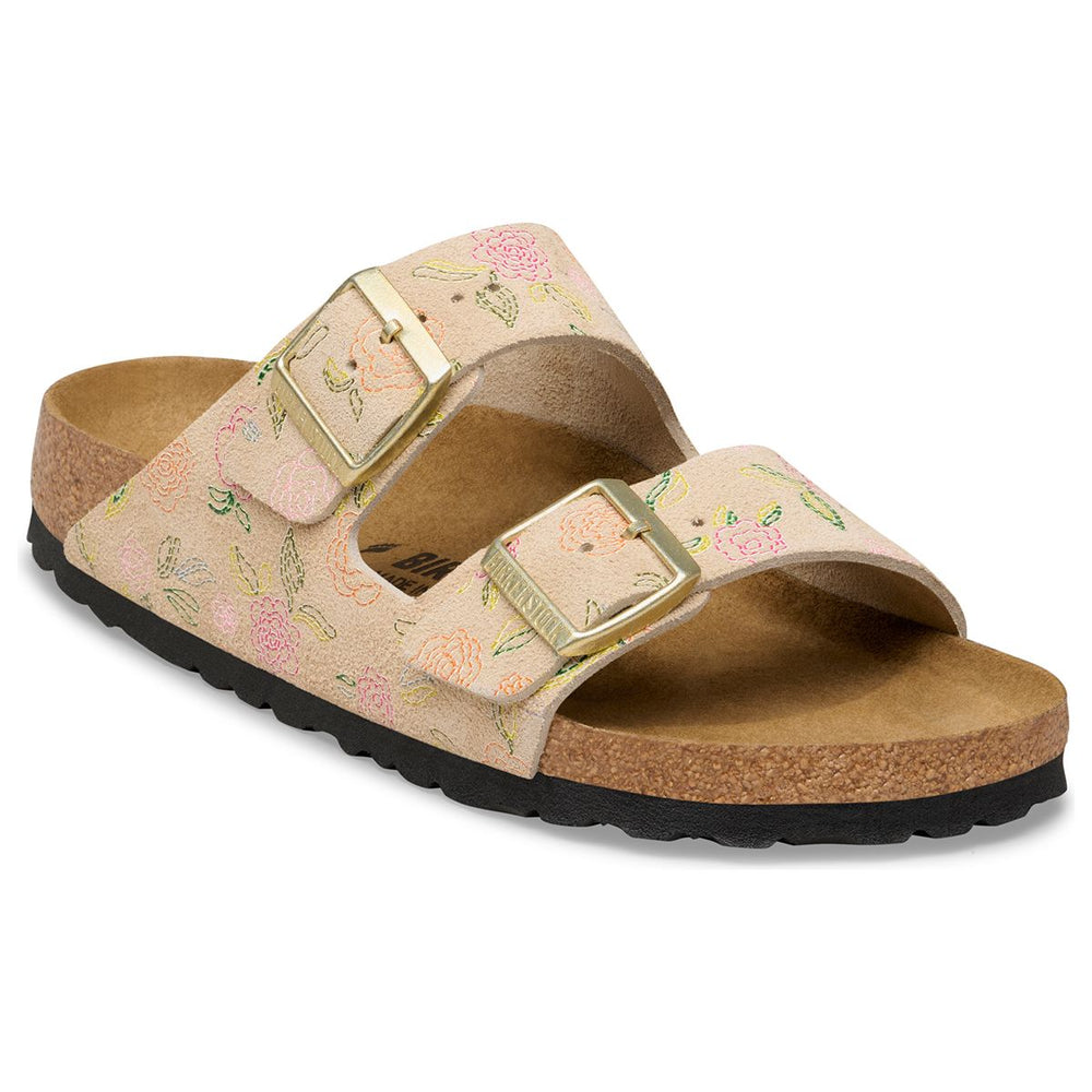 Beige suede two-strap slide sandal with a colourful floral pattern, gold buckles, and a natural cork footbed. Style #1031694.