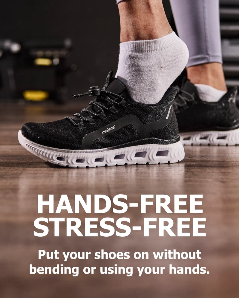 Person wearing black athletic shoes with text 'HANDS-FREE STRESS-FREE' on a wooden floor.