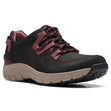 Women’s black nubuck sneaker with dark red textile accents, striped laces, and a speckled beige rocker sole. Style #26168583.