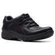 Women’s all-black leather walking sneaker featuring integrated athletic laces and a thick, textured black sole. Style #26174865.