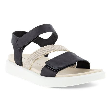 A black and beige ECCO FLOWT flat sandal with an adjustable toe strap and ankle strap, featuring a luxurious leather upper and a soft microfiber footbed.