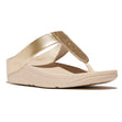 FitFlop Fino women's leather sandal featuring a slim toe-post design, glossy leather upper, and ergonomic cushioned sole for sleek, supportive wear.

