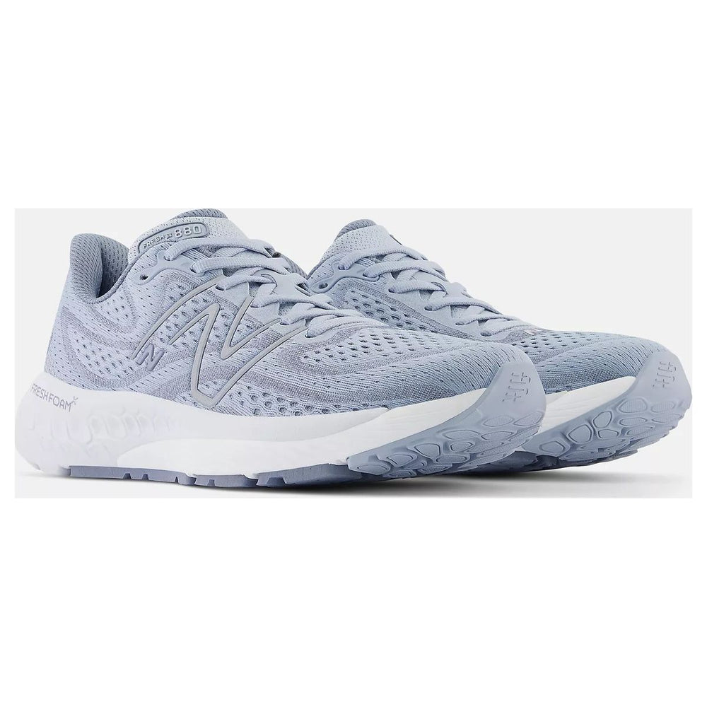Women's light blue-grey engineered mesh running shoes with a grey side logo and thick white cushioned sole. Style #W880G13.
