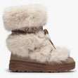 Olang beige winter boot with fluffy faux fur cuffs, patterned shaft, front lace tie, and thick rubber lug sole.