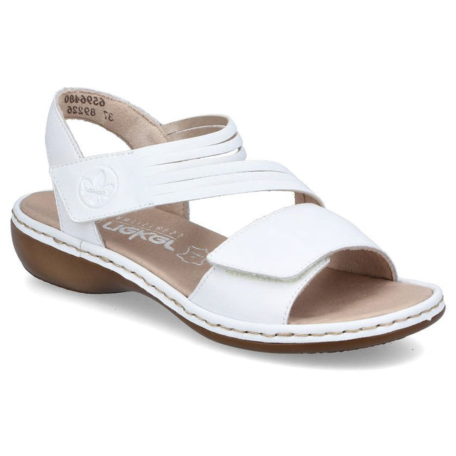 Women’s white leather sandal with adjustable velcro straps, a tan cushioned footbed, and a low wedge heel. Style #65964-80.