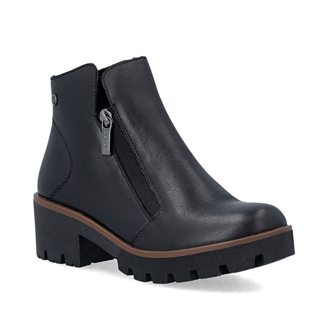 Black leather short ankle boot with dual side zippers, brown welt detail, and thick lugged sole. Style # 79254-00