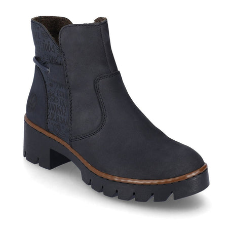 A pair of navy blue mid-height slip-on boots with a block heel and a visible zipper on the side. Rieker X5755-14