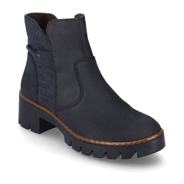 A pair of navy blue mid-height slip-on boots with a block heel and a visible zipper on the side. Rieker X5755-14