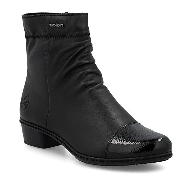 Black leather mid-height boot with ruched shaft, glossy patent toe cap, side zip, and low block heel. Style # Y0773-00