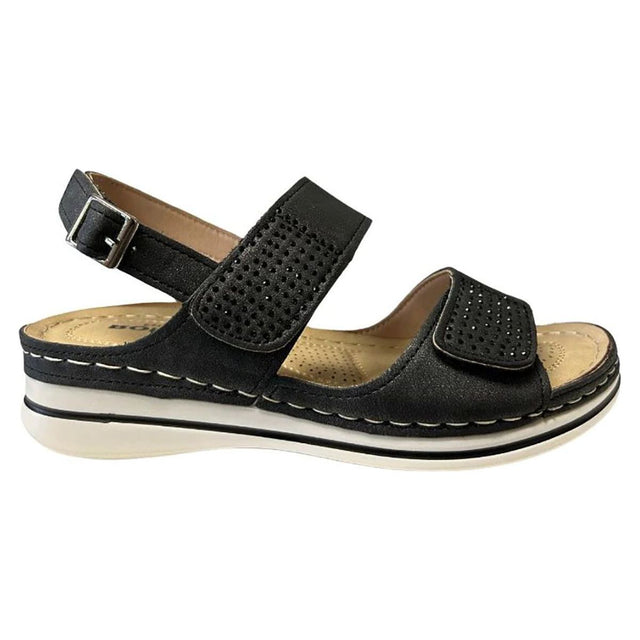 Women's black textured strap sandal with a silver buckle, patterned details, and a layered white sole. Style #537851-100.