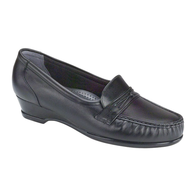 Black moccasin-style loafer with decorative saddle detail, cushioned TRIPAD® footbed, hidden elastic panels, and low wedge heel for ease and comfort. Style #0128-013