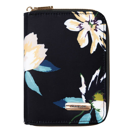 Black zip-around passport wallet featuring a large cream and green floral print and a gold logo plate. Style #43401-50C