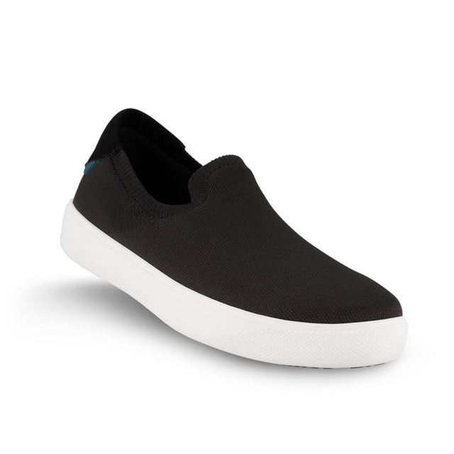 Black Vessi waterproof slip-on sneaker with a knit upper, white sole, and a small teal tag on the heel, SHBWBBW